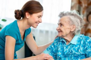 Caregiver Assisting Elderly Woman